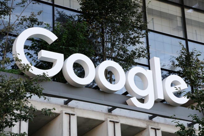 The Google logo hangs on the door of the company's building in New York.